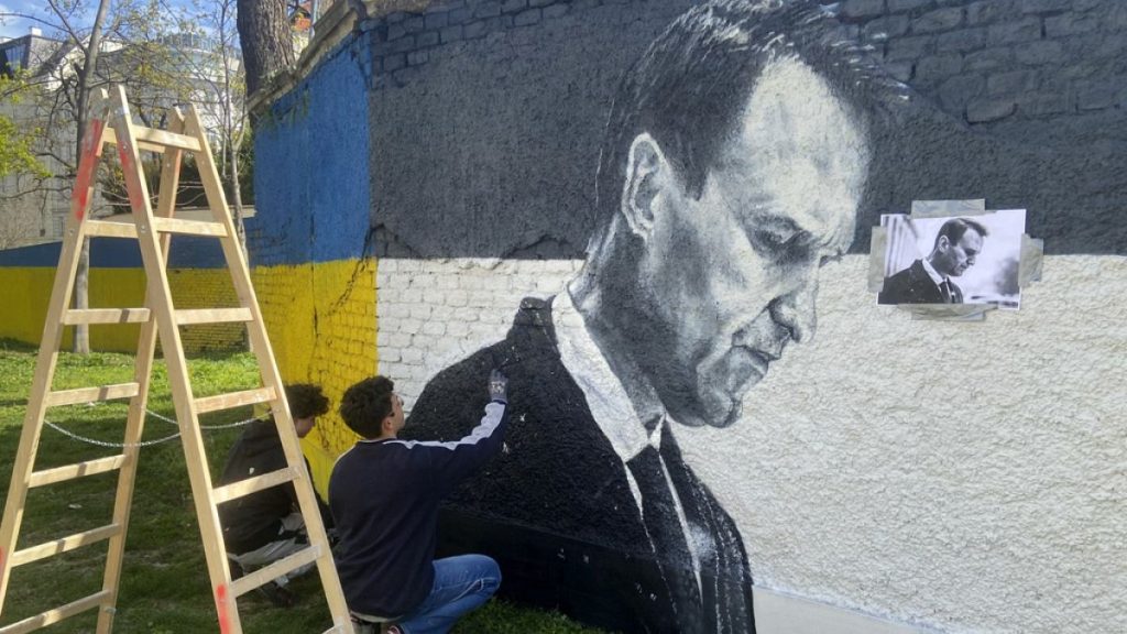 Austrian graffiti duo Joel Gamnou paint a picture of Alexei Navalny on a wall in Vienna, Austria, Wednesday, 27 March 2024.