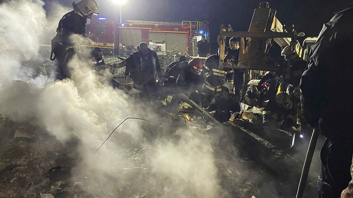 Emergency services work at the scene of a building that was damaged by a Russian drone attack in Vinnytsia, Ukraine