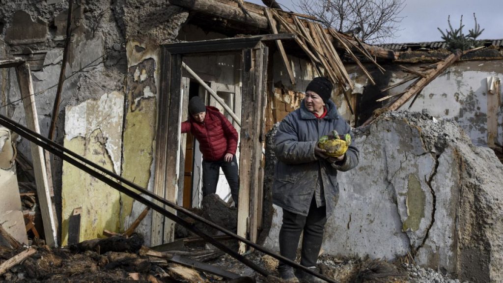 Inna, 71, holds food items outside her house which was destroyed by a Russian drone attack in Zaporizhzhia, Ukraine, on Thursday, March 28th 2024