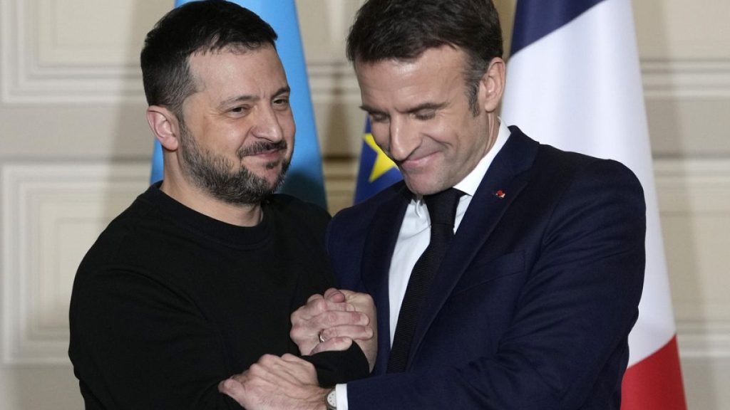 Ukrainian President Volodymyr Zelenskyy, left, and French President Emmanuel Macron shake hands after a press conference, on Feb. 16, 2024