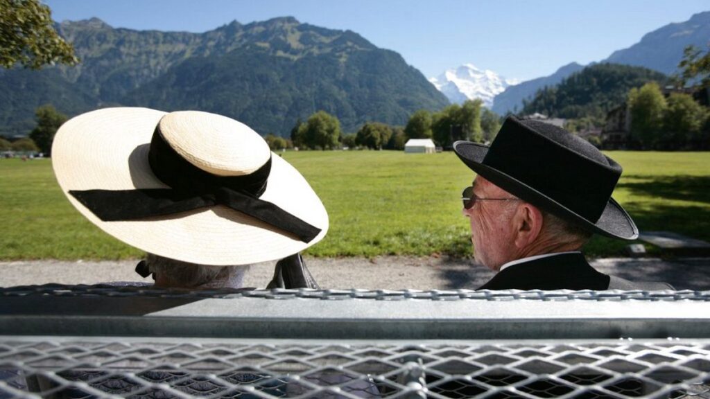 A couple in traditional costumes sits on a bench on Friday, September 1, 2006.