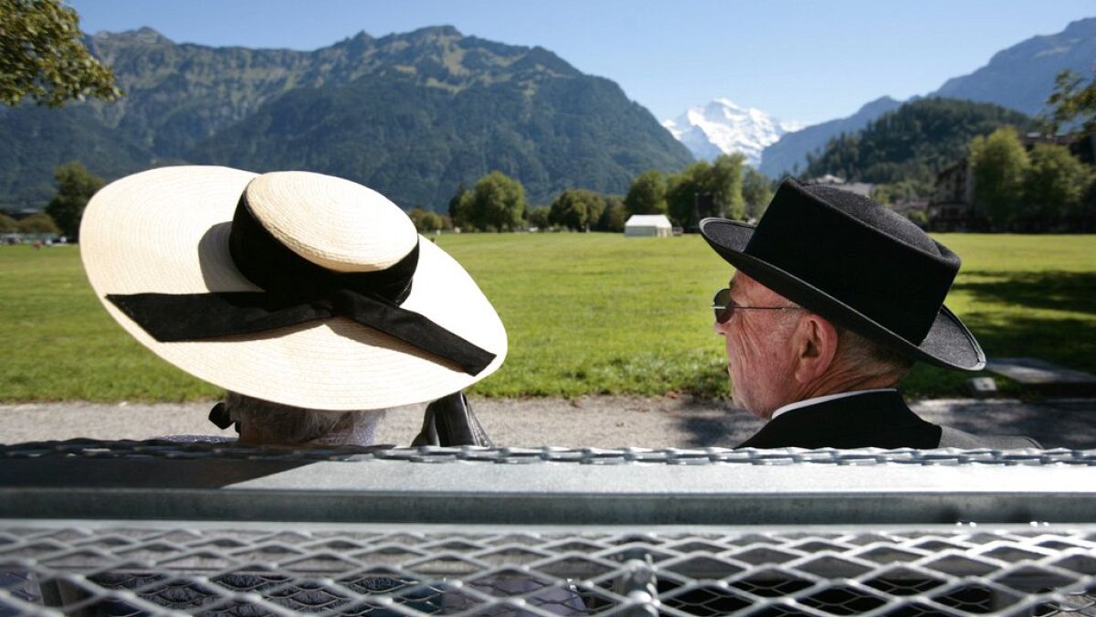 A couple in traditional costumes sits on a bench on Friday, September 1, 2006.