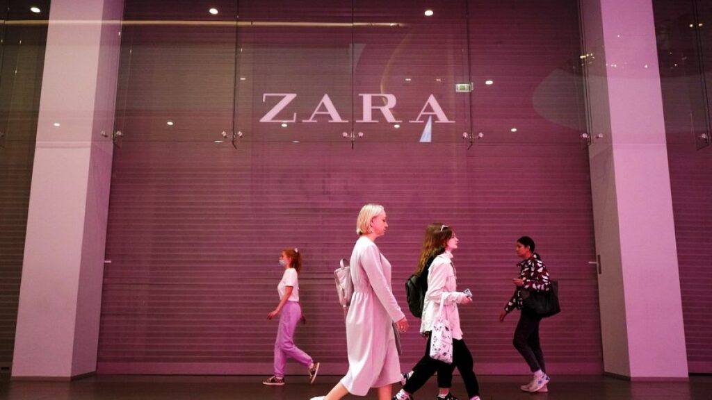 People walk past a Zara shop closed due to sanctions in a shopping mall in St. Petersburg, Russia, Tuesday, May 31, 2022.