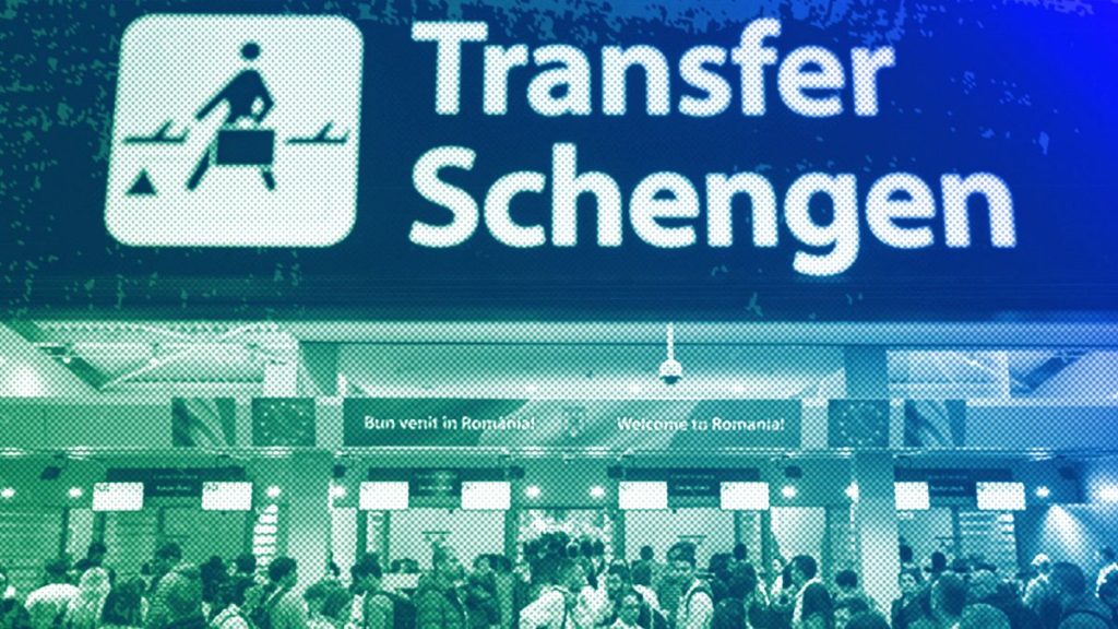 Passengers arriving at the Henri Coanda International Airport pass under a Schengen Information sign, in Otopeni, near Bucharest, March 2024
