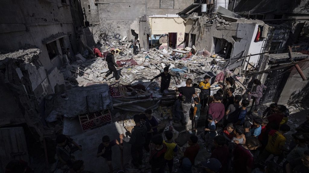 A family inspects their house after it was hit by an Israeli airstrike in Rafah, southern Gaza, April 4, 2024