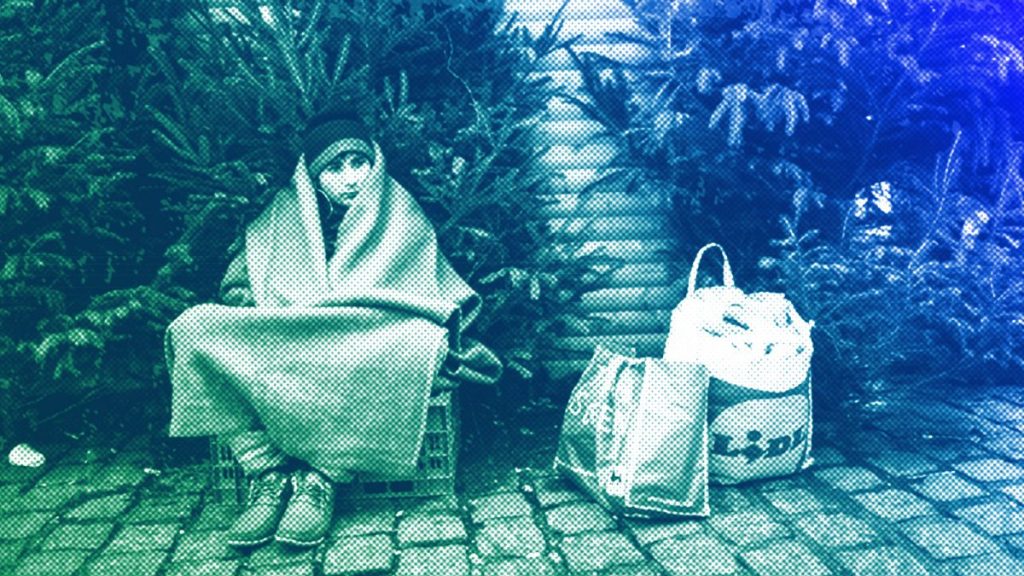 A person camps outside the city hall of Mons, December 2013