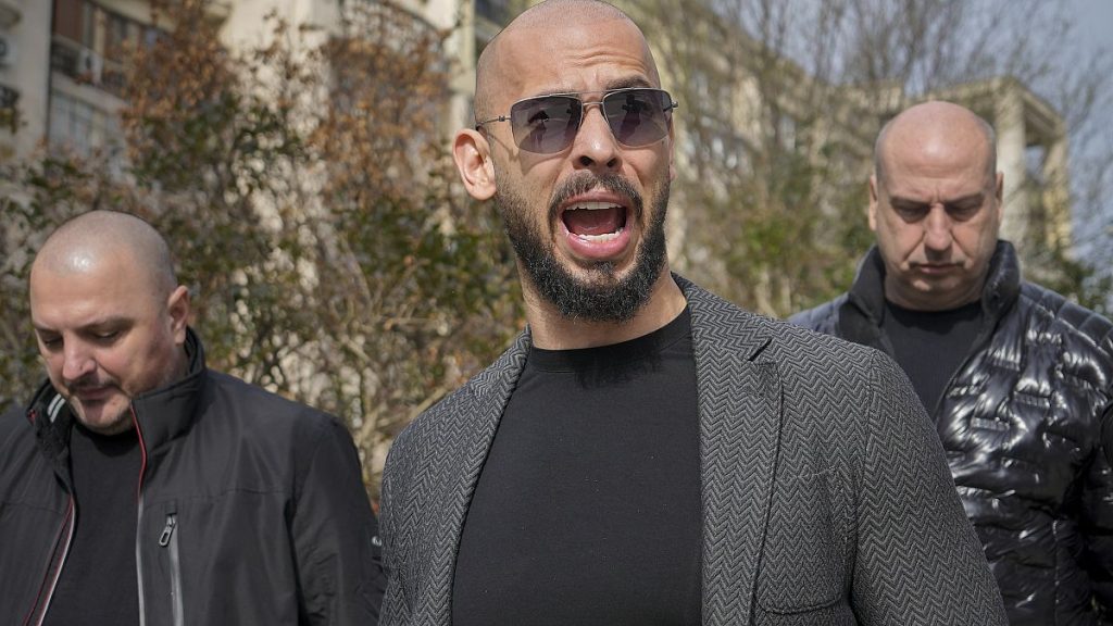 Andrew Tate grimaces as he arrives at the Bucharest Tribunal in Bucharest, Romania, Monday