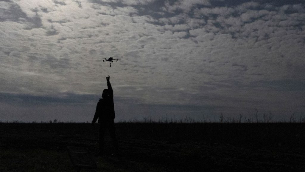 A Ukrainian serviceman from Code 9.2 unit known by call sign Mamay catches a drone at the frontline, few kilometres from Bakhmut, Donetsk region, Ukraine, 24/04/24.