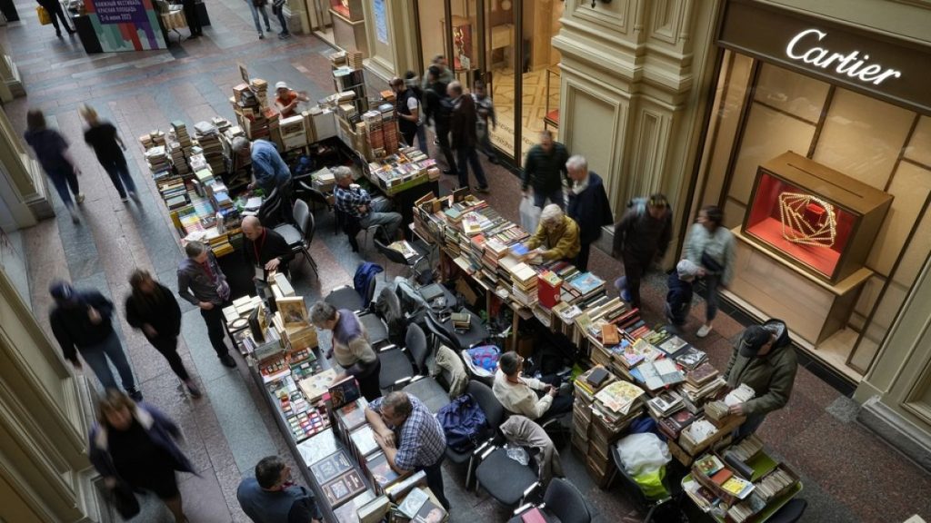 Visitors gather at a book shop during an annual book festival, celebrating Alexander Pushkin