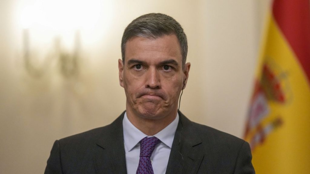 Spanish Prime Minister Pedro Sanchez grimaces during a press conference after meeting with Slovenia