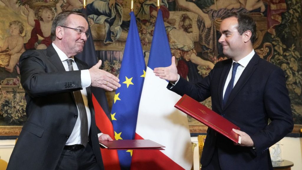 French Defense Minister Sebastien Lecornu, right, and his German counterpart Boris Pistorius shake hands after signing an agreement in Paris on Friday, April 26, 2024.