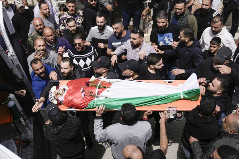 Des Palestiniens se rassemblent à côté du corps d'Omar Hamed lors de ses funérailles au village de Beitin, près de la ville cisjordanienne de Ramallah, en Cisjordanie occupée, dimanche 14 avril.