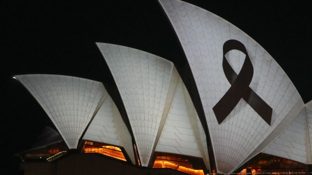 Sydney Opera House is illuminated with a black ribbon Monday, April 15, 2024, as part of the national day of mourning following stabbing deaths of several people at a shop