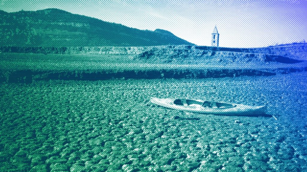 An abandoned canoe sits on the cracked ground amid a drought at the Sau reservoir, north of Barcelona, January 2024