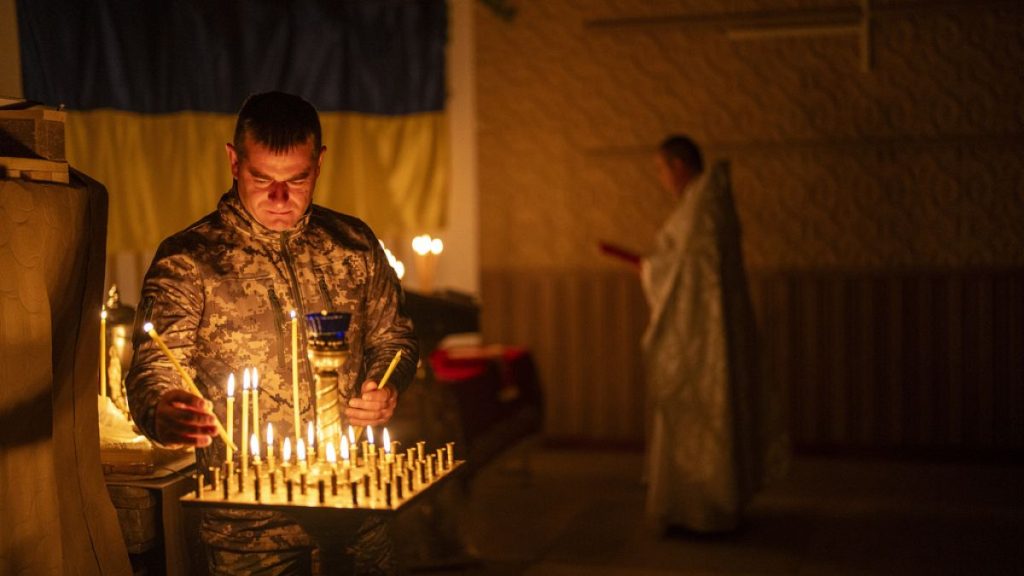 An Ukrainian serviceman of the 72nd Separate Mechanized Brigade, lights candles during a Christian Orthodox Easter religious service, in Donetsk region, Ukraine, 4 May, 2024.