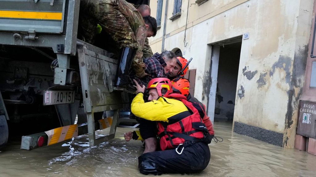 Firefighters rescue an elderly man in the flooded village of Castel Bolognese, Italy.