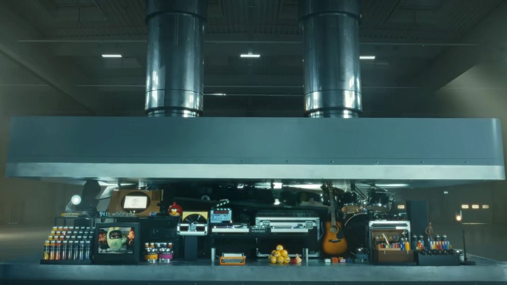 A hydraulic press crushes an array of creative instruments in a still from Apple
