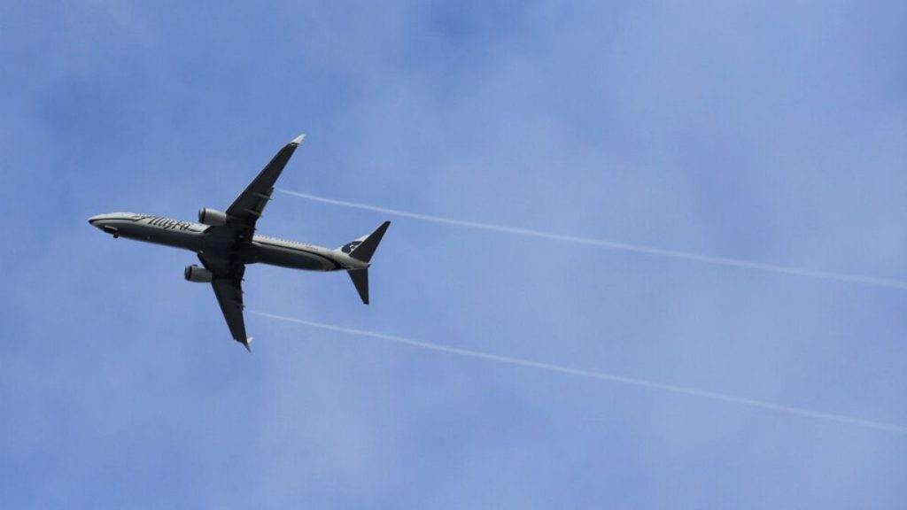 FILE - An Alaska Airlines Boeing-made airplane flies above Boeing
