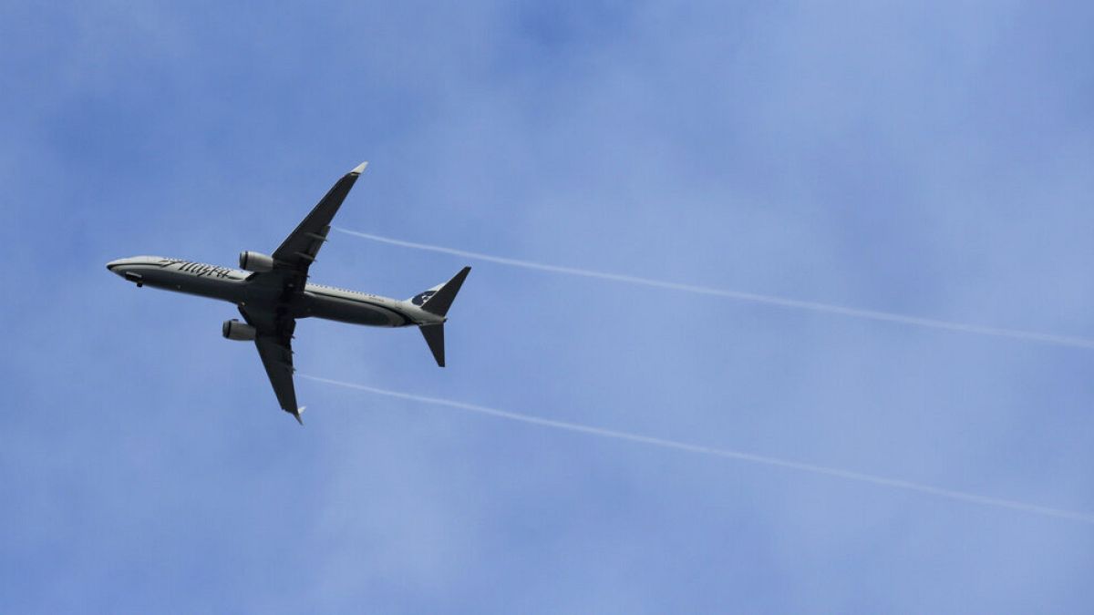 FILE - An Alaska Airlines Boeing-made airplane flies above Boeing
