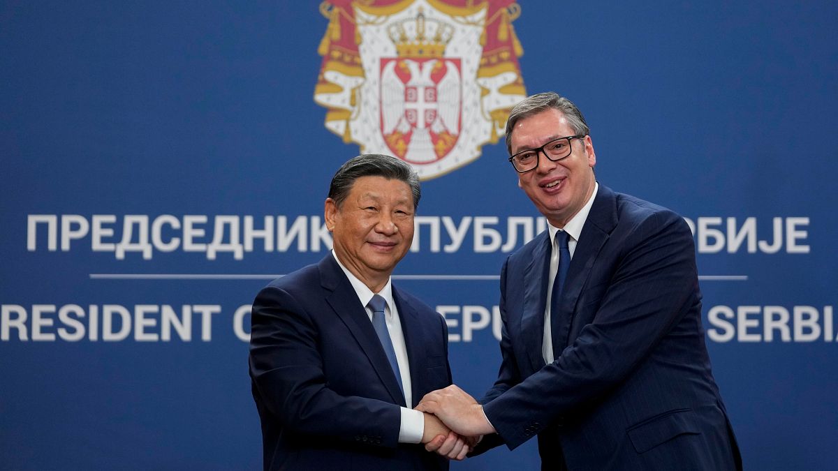 Chinese President Xi Jinping shakes hands with Serbian President Aleksandar Vucic.