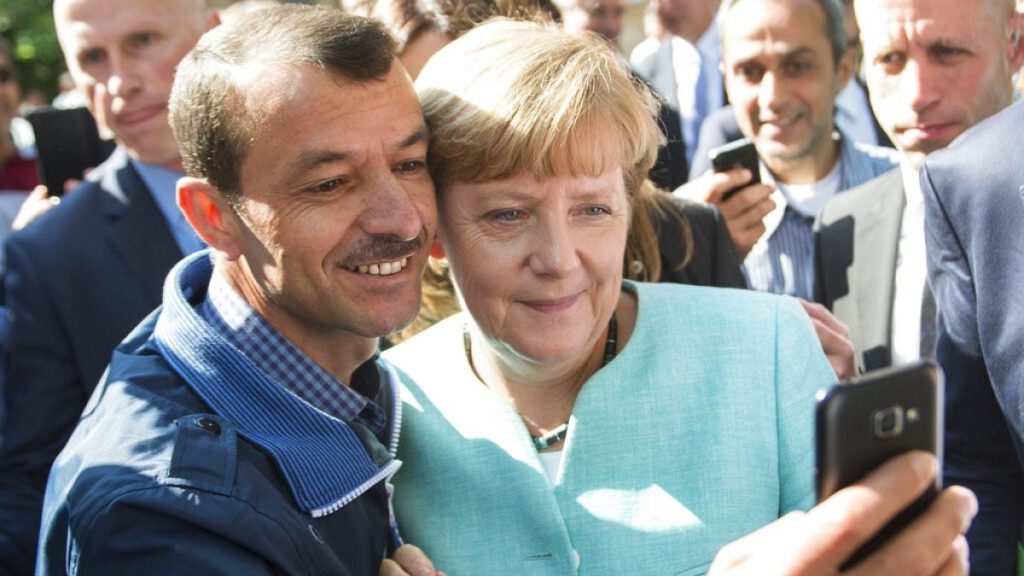 German chancellor Angela Merkel poses for a selfie with a refugee in a facility for arriving refugees in Berlin. 9 Sept. 2015.