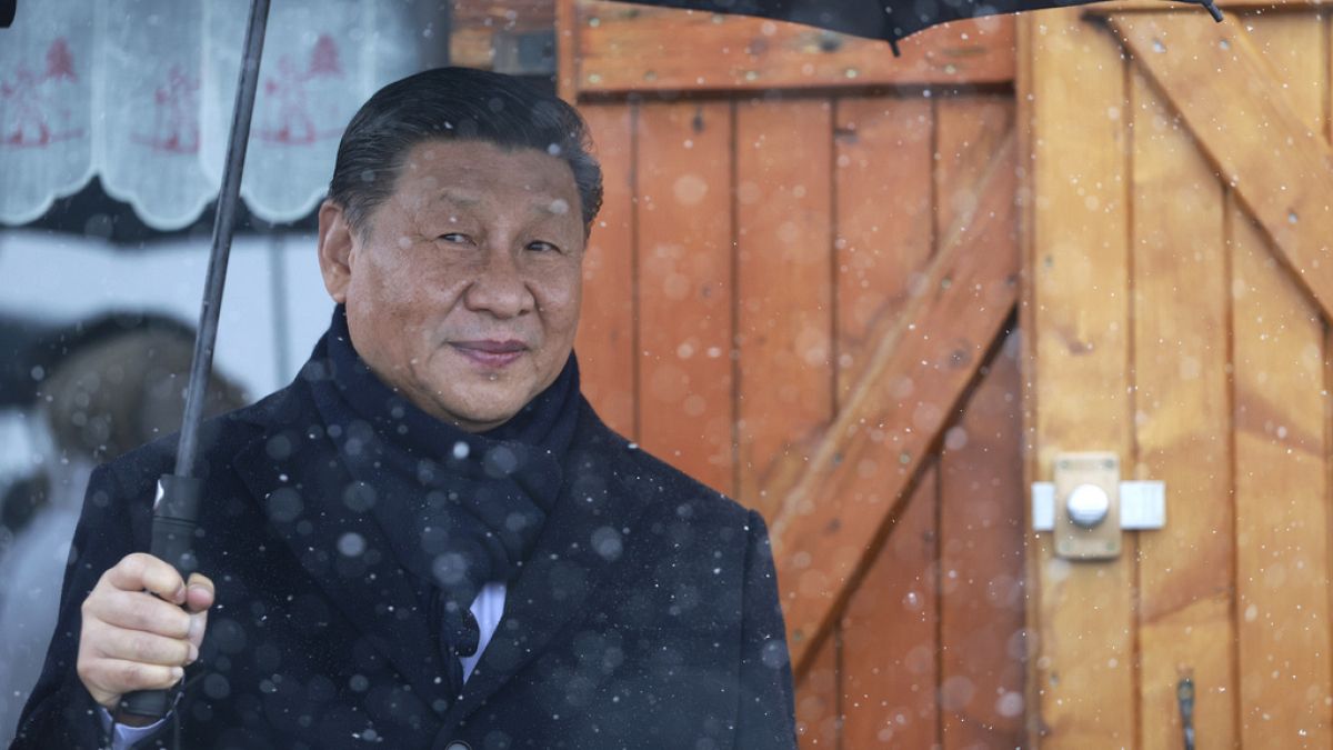 Chinese President Xi Jinping holds an umbrella outside a restaurant Tuesday, May 7, 2024 at the Tourmalet pass, in the Pyrenees mountains.