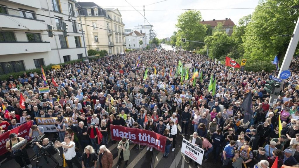 Demonstrators take part in a rally to mark an attack on an SPD politician stand on Pohlandplatz, in Dresden, Germany, Sunday May 5, 2024.
