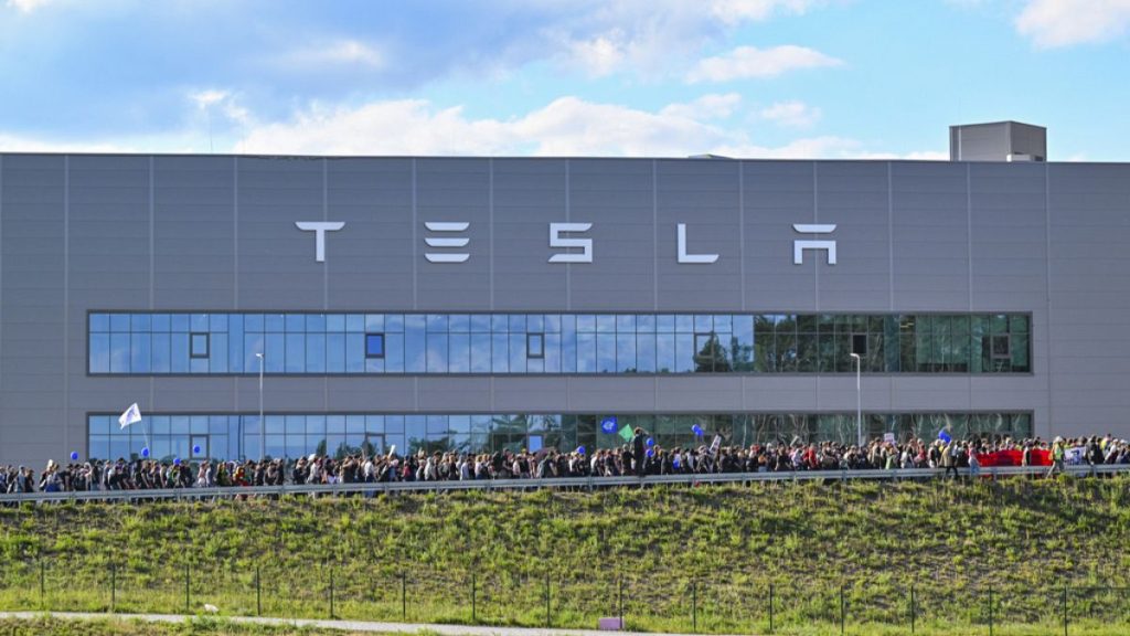Demonstrators walk past the Tesla factory in Gruenheide, Germany, May 11, 2024, at the end of their protest.