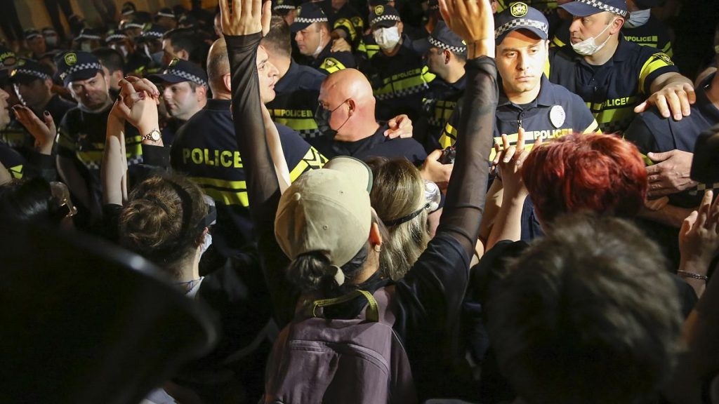 A demonstrator gestures while arguing with the police during a protest against the