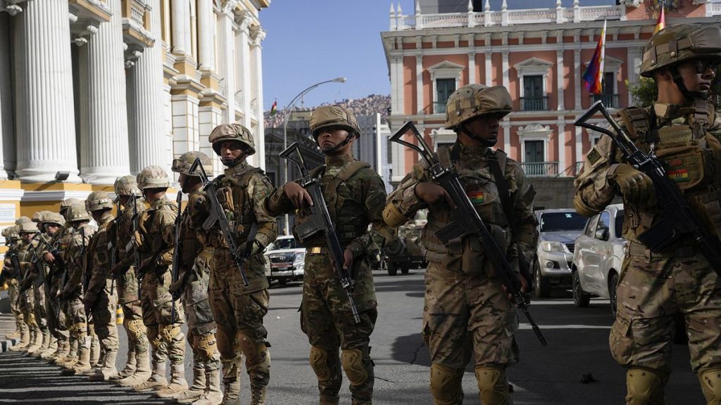 Soldiers block the street in front of the presidential palace, right, and the Legislative Assembly, left, in Plaza Murillo in La Paz, 26 June 2024