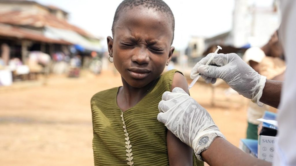 A health worker administers a cervical cancer vaccine HPV Gardasil to a girl on the street in Ibadan, Nigeria.