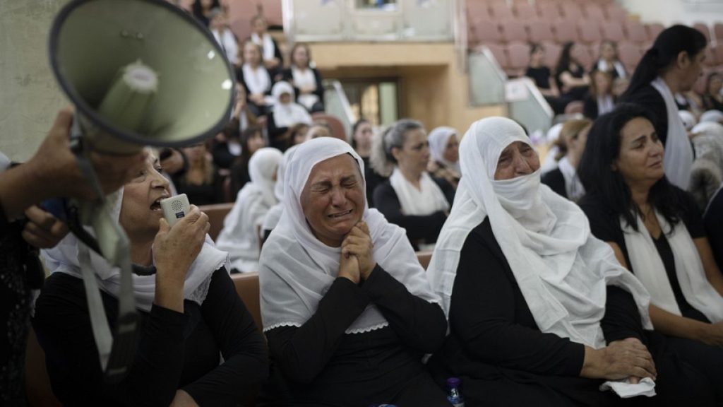 Members of the Druze minority attend a memorial ceremony for the children and teens, killed in a rocket strike in the village of Majdal Shams (AP Photo/Leo Correa)