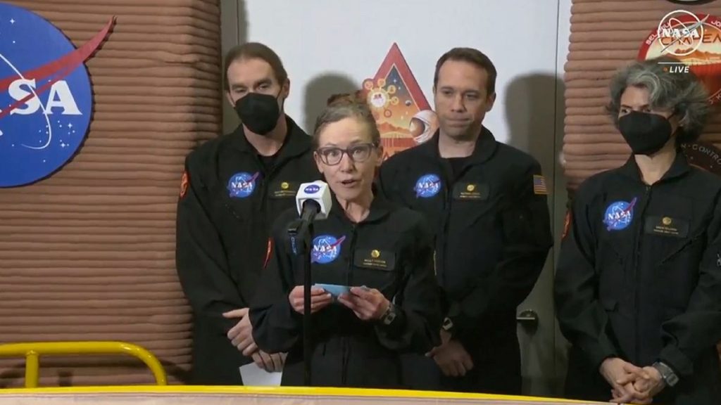 Kelly Haston, a crew member of the first CHAPEA mission, speaks in front of other members at Johnson Space Center in Houston, Texas.