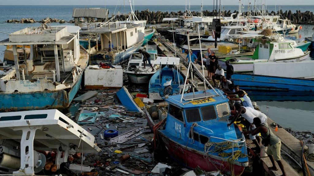 Fishermen push a boat damaged by Hurricane Beryl at the Bridgetown fisheries, Barbados, Tuesday, 2 July, 2024.