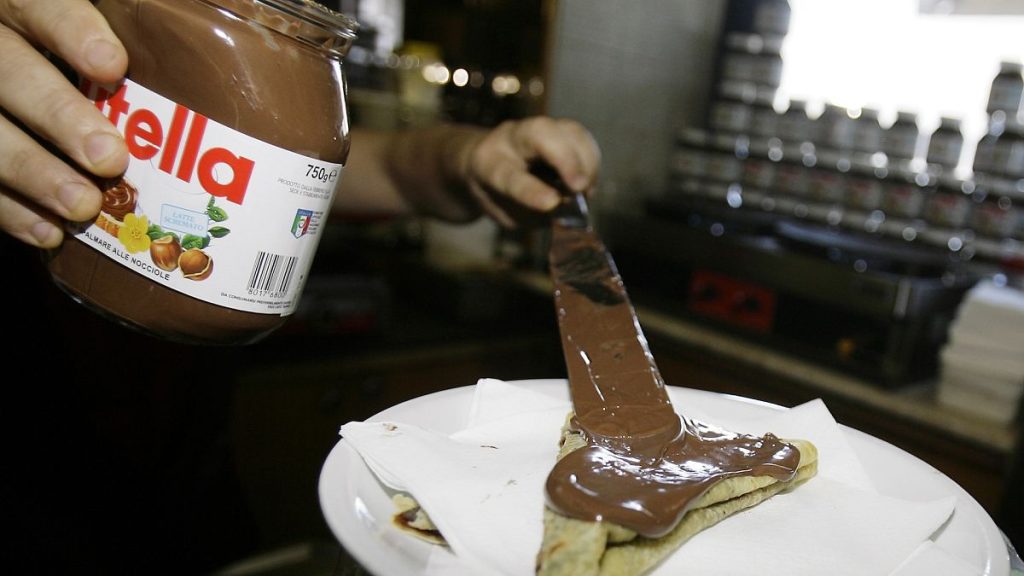 A bartender in Rome spreads Nutella on a crepe