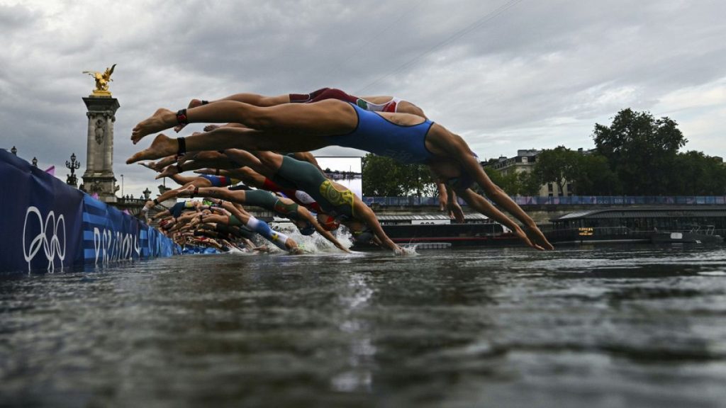 Athletes compete in the swimming race in the Seine during the women