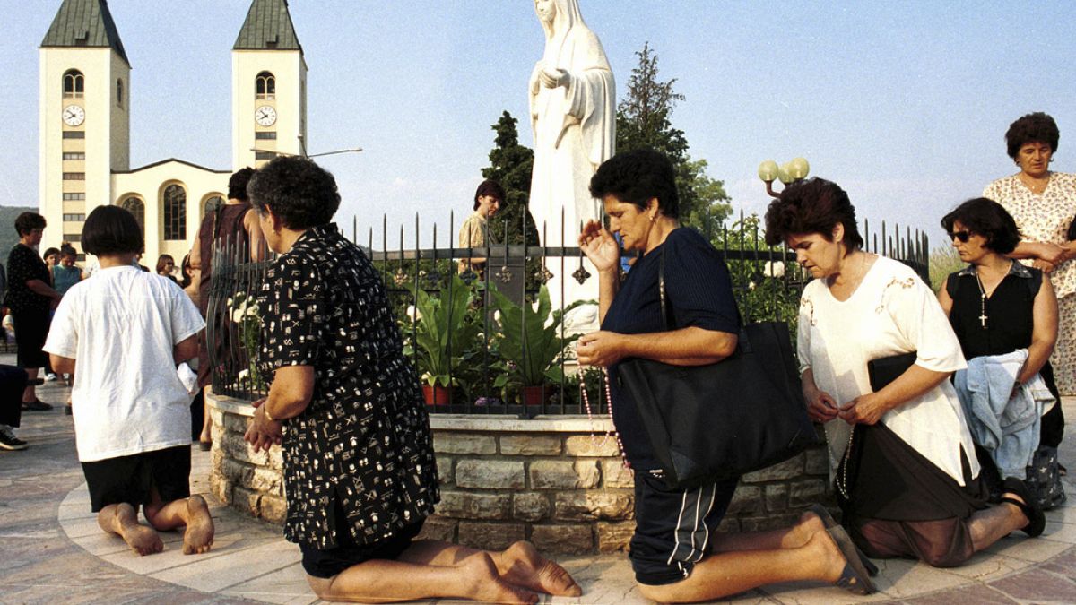 Roman Catholic women pray on feast of the Assumption in Medjugorje, some 120 kilometers (75 miles) south of the Bosnian capital, Sarajevo, on Aug. 15 2000