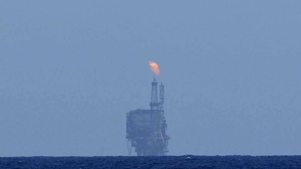An oil platform is visible on the horizon in international waters zone near Libya, Mediterranean Sea