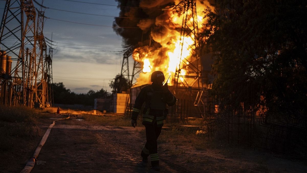 A Ukrainian firefighter talks on the radio while he works to extinguish the fire on the site of an electrical substation in Dnipropetrovsk region, Ukraine, Sept. 2, 2024