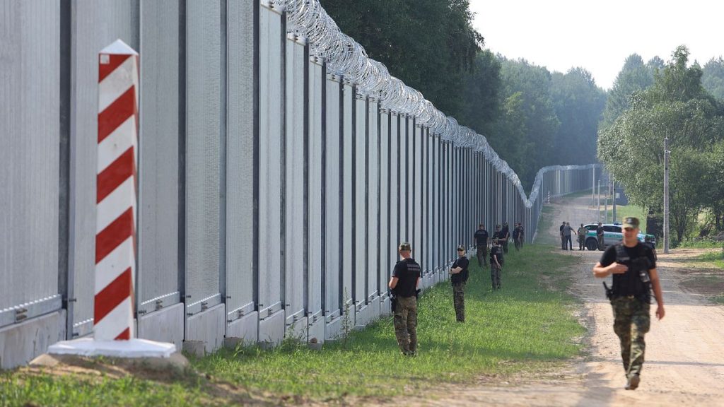 FILE - Polish border guards patrol a metal wall on the border between Poland and Belarus, near Kuznice, Poland.