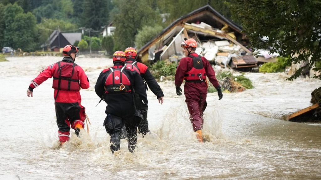 Firefighters walk through a flooded road in Jesenik, Czech Republic, 15 September 2024