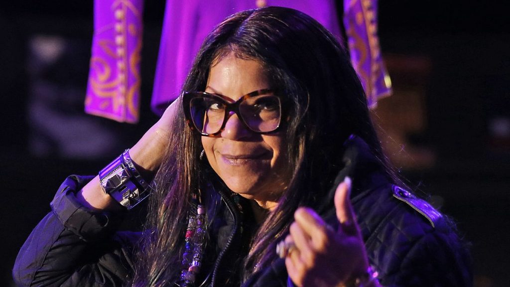 Tyka Nelson, sister of the late musician Prince, appears in front of his costumes at the