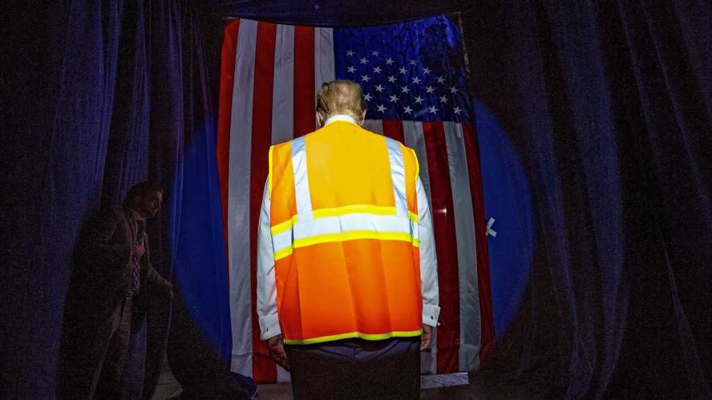 Former President Donald Trump arrives wearing an reflective safety vest for a campaign rally in Winsconsin