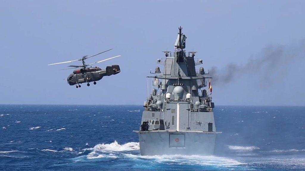 Russian frigate Admiral Grigorovich sails while the Kamov Ka-27 helicopter takes off from its flight deck during drills off the coast of Tartus, Syria.