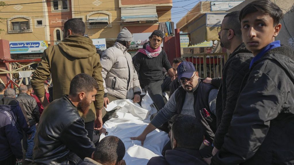 The bodies of civilian victims of an overnight Israeli air strike on the Nuseirat refugee camp arrive at the Al-Aqsa Martyrs hospital in Deir al-Balah, 12 December, 2024