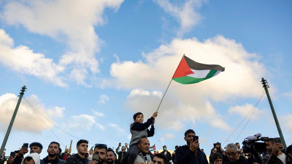 People attend a rally celebrating the fall of Syrian President Bashar Assad