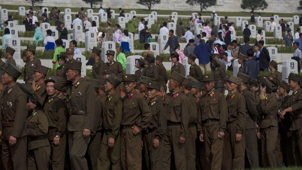 North Korean soldiers and civilians tour a cemetery for Korean War veterans on Thursday, July 25, 2013 in Pyongyang, North Korea