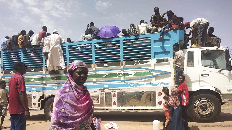 People board a truck as they leave Khartoum, Sudan, on 19 June, 2023.