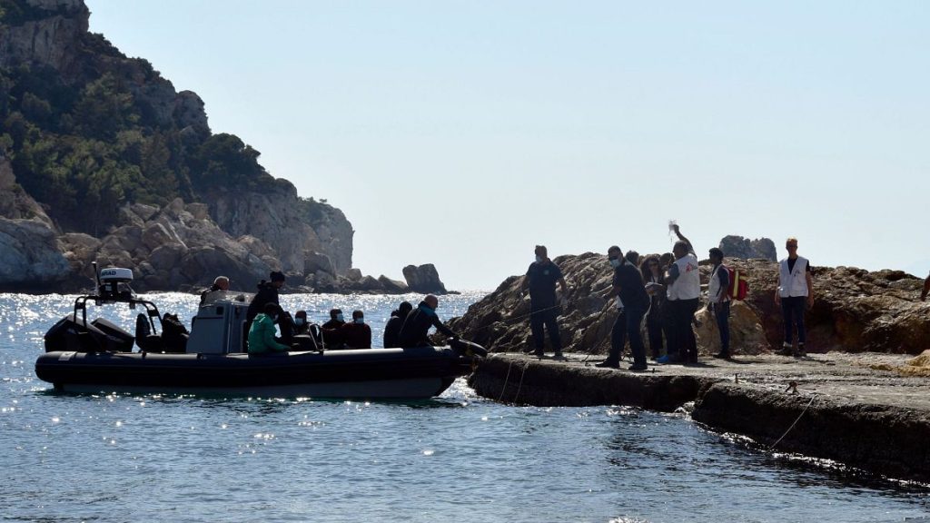 Members of Doctors Without Borders and coast guards officers help a pregnant woman to embark on a vessel with other survivors in Greece, 23 September 2024.