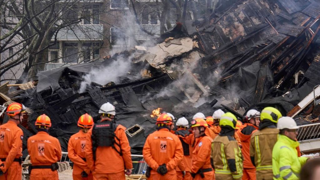 Firefighters stand by a destroyed building at the site of an explosion which destroyed several apartments and injured multiple people, at The Hague, Saturday, Dec. 7, 2024.